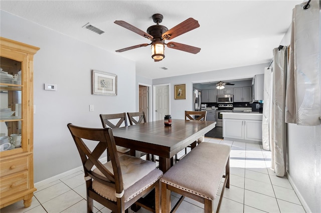 dining area featuring ceiling fan and light tile floors