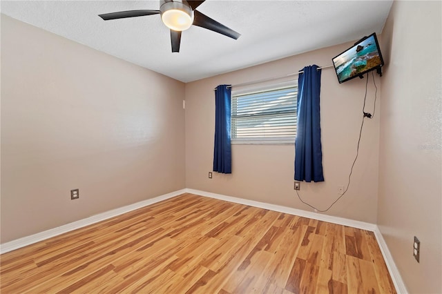 empty room featuring ceiling fan and light wood-type flooring