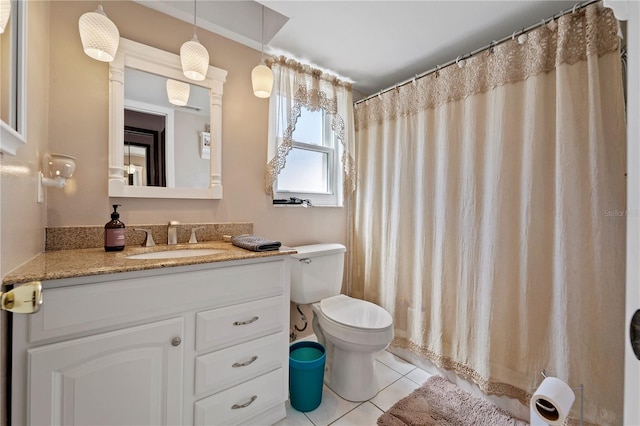 bathroom featuring vanity, tile flooring, and toilet