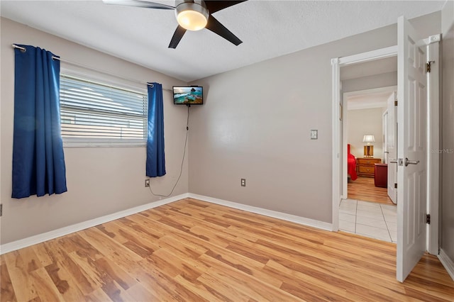 unfurnished room featuring light hardwood / wood-style floors and ceiling fan