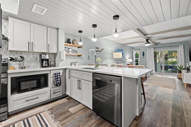 kitchen with kitchen peninsula, a kitchen breakfast bar, stainless steel dishwasher, white cabinets, and dark hardwood / wood-style floors