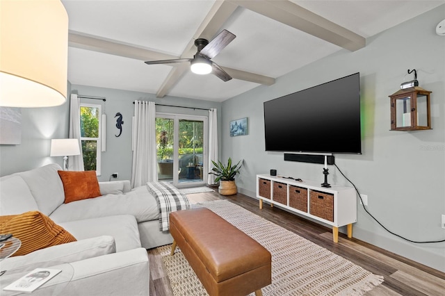 living room featuring hardwood / wood-style flooring, ceiling fan, and beamed ceiling