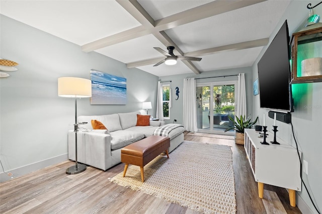 living room featuring beam ceiling, ceiling fan, light hardwood / wood-style floors, and coffered ceiling