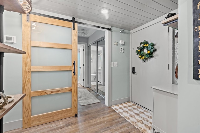 foyer featuring a barn door and light hardwood / wood-style flooring