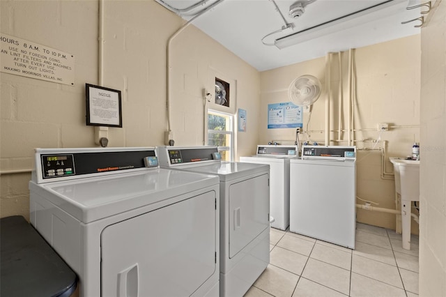 clothes washing area featuring washing machine and clothes dryer and light tile patterned floors