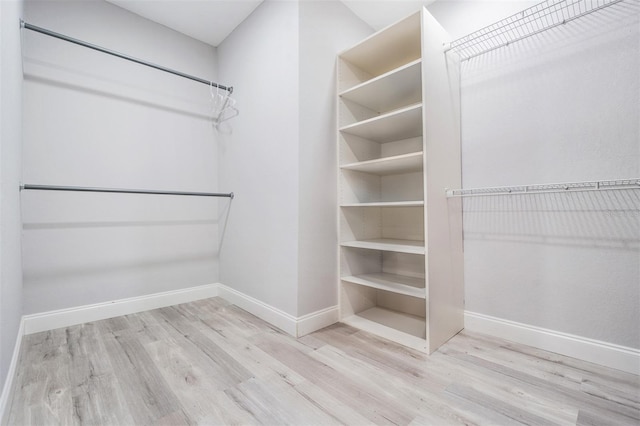 spacious closet featuring light hardwood / wood-style floors