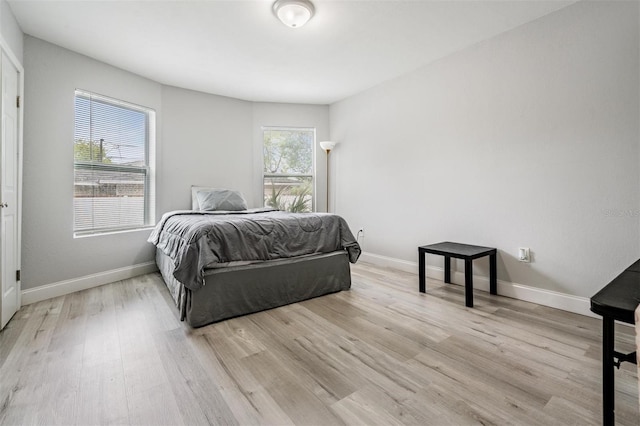 bedroom featuring light wood-type flooring and multiple windows