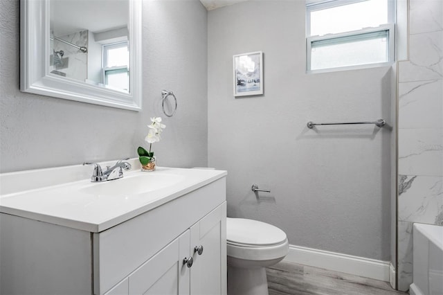 bathroom with hardwood / wood-style floors, toilet, and large vanity