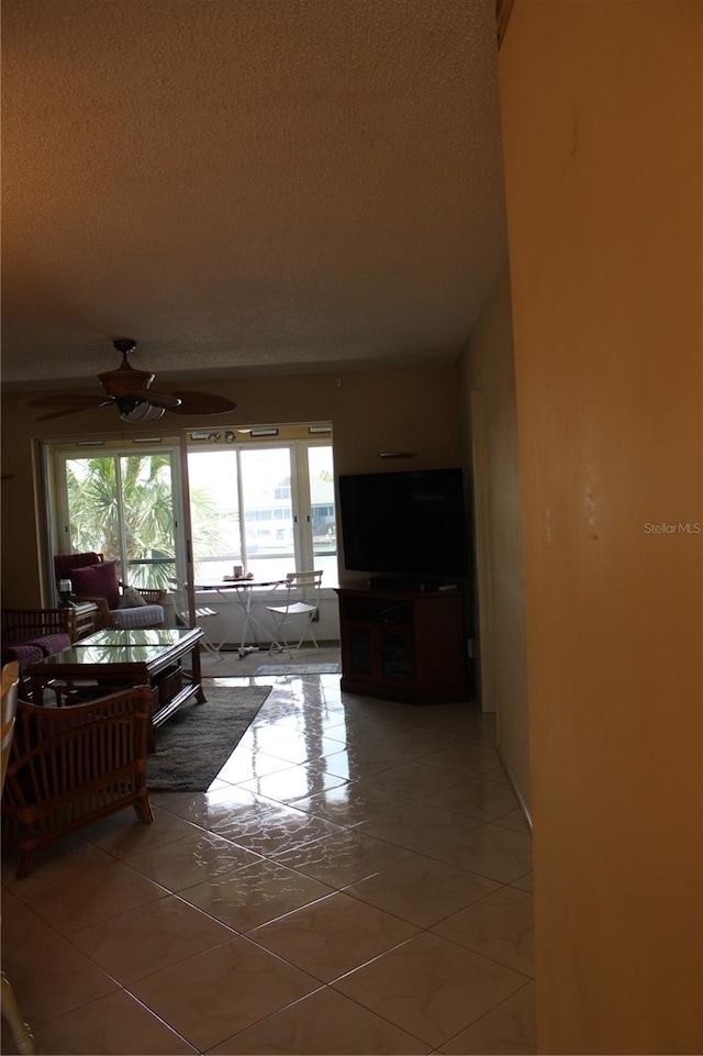 living room featuring tile floors and ceiling fan