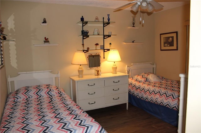 bedroom featuring ceiling fan and dark wood-type flooring