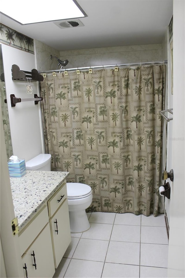 bathroom with tile flooring, vanity, and toilet