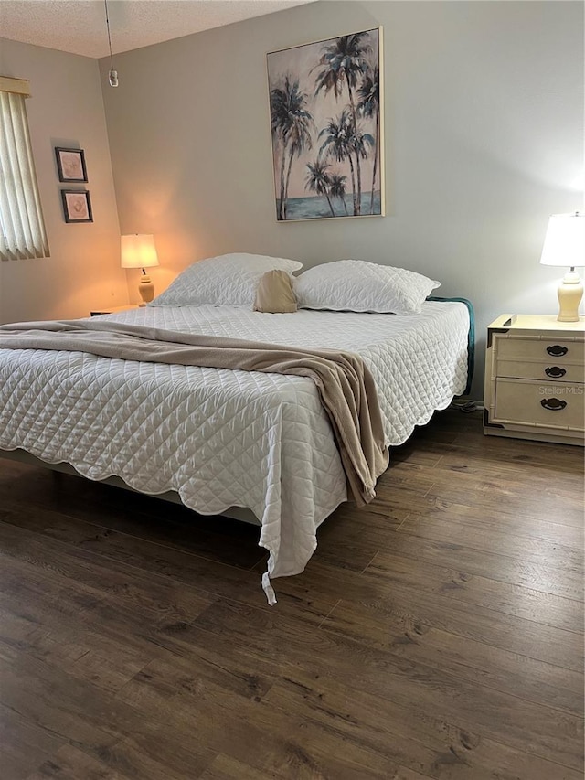 bedroom with dark wood-type flooring