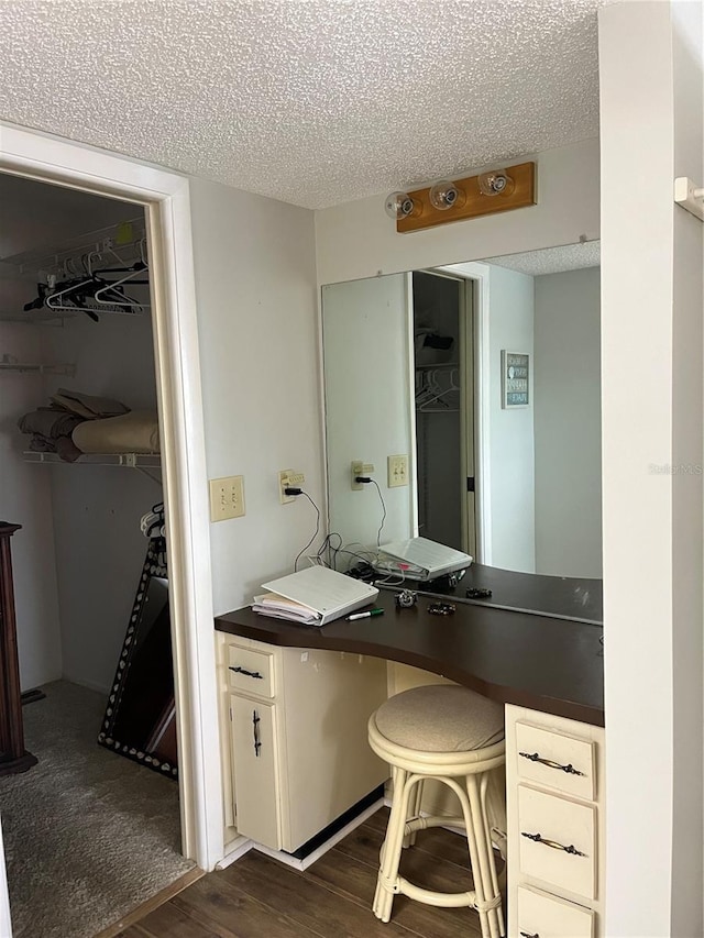 bathroom with a textured ceiling and wood finished floors