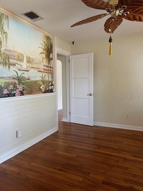 unfurnished room featuring ceiling fan and dark hardwood / wood-style floors