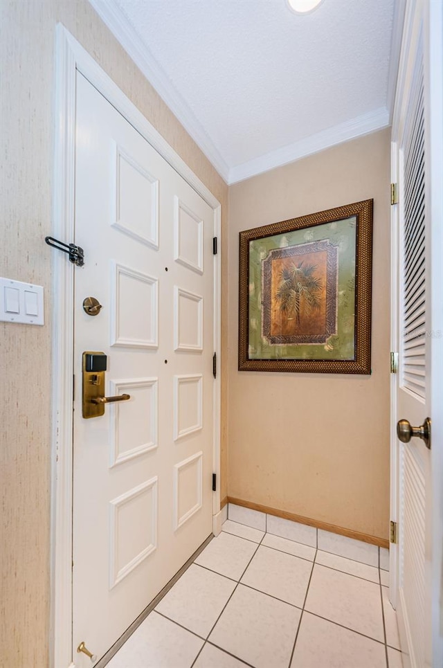 tiled foyer entrance with ornamental molding