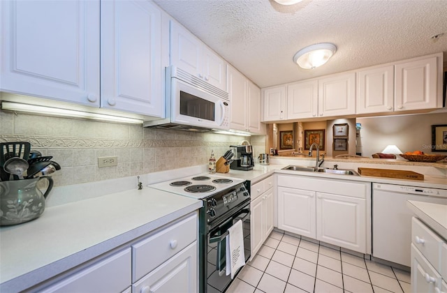 kitchen featuring white appliances, white cabinetry, and sink