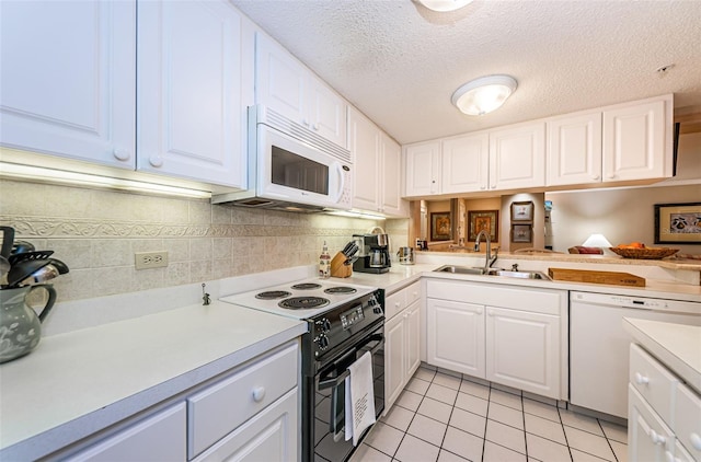 kitchen with light tile floors, white appliances, white cabinetry, backsplash, and sink