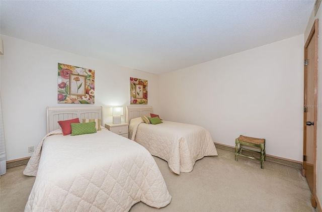 bedroom with light carpet and a textured ceiling