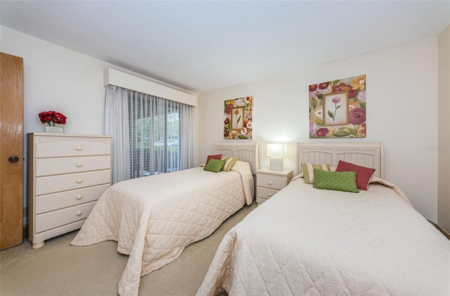 bedroom with light carpet and a textured ceiling