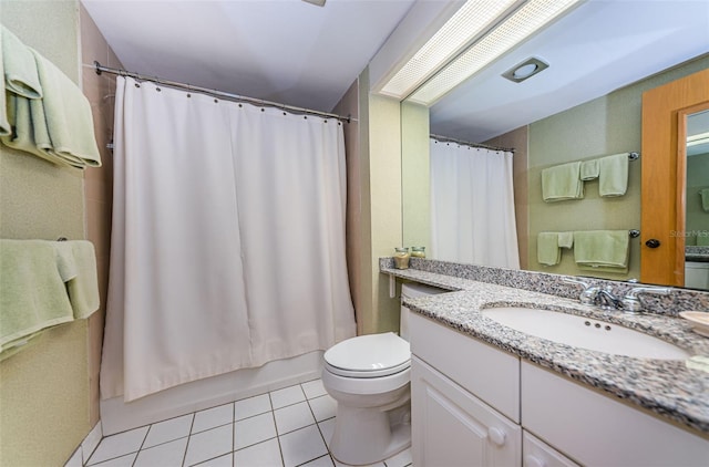 full bathroom featuring toilet, tile floors, large vanity, and shower / bath combo