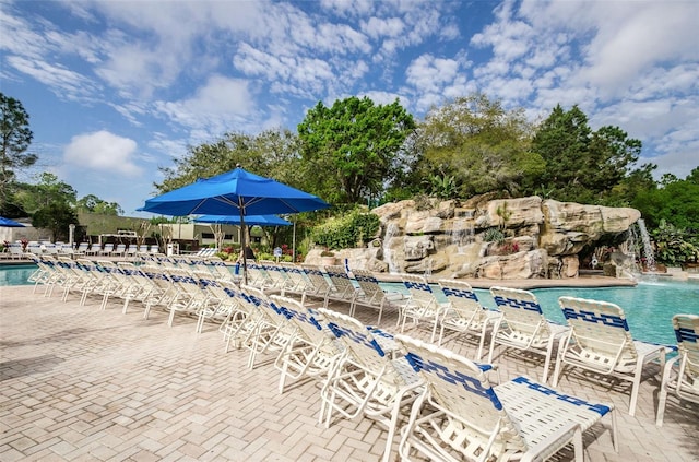 view of swimming pool featuring a patio area and pool water feature