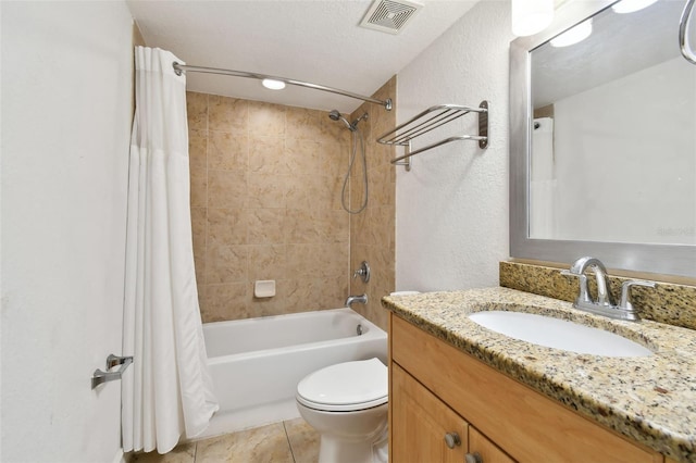 full bathroom with shower / bath combo with shower curtain, toilet, vanity with extensive cabinet space, a textured ceiling, and tile floors