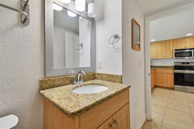 bathroom featuring tile flooring and vanity