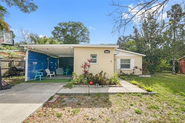 rear view of property featuring a patio and a yard