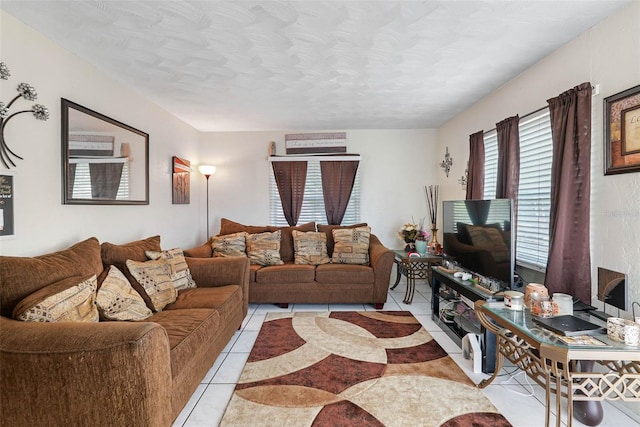 living room featuring a textured ceiling and light tile flooring