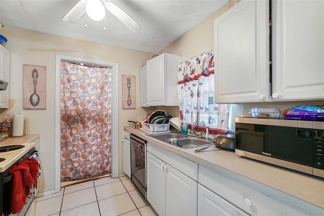 kitchen featuring black dishwasher, ceiling fan, white cabinets, and light tile floors