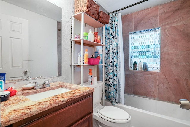 full bathroom featuring toilet, vanity, and shower / tub combo with curtain