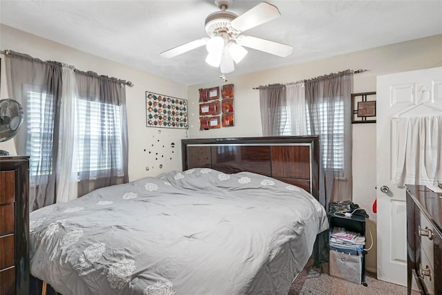 bedroom with ceiling fan and carpet floors