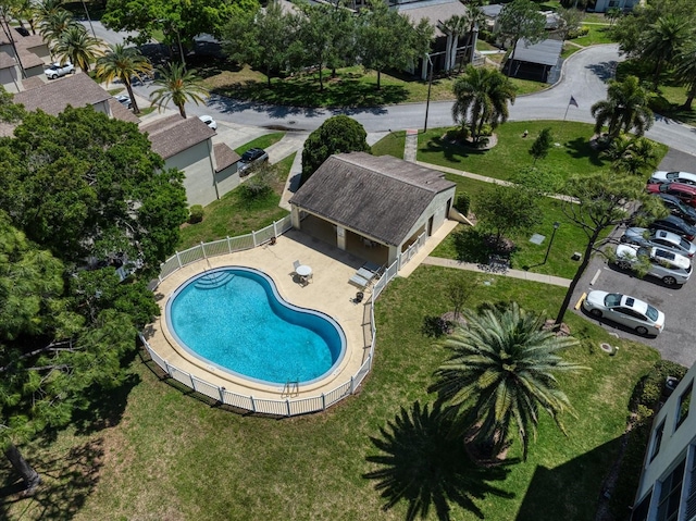 view of pool featuring a lawn