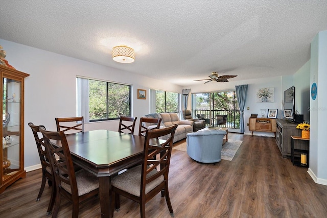 dining area with ceiling fan, plenty of natural light, and dark hardwood / wood-style floors