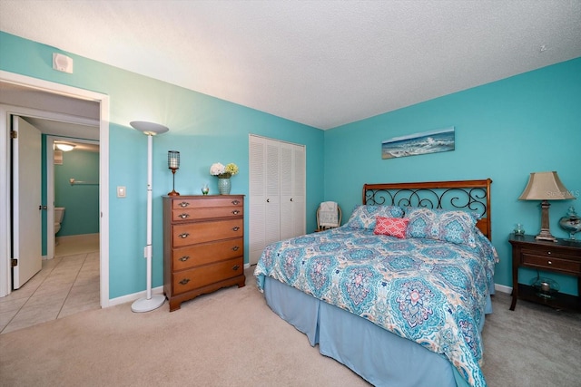 bedroom with light colored carpet, a closet, and a textured ceiling