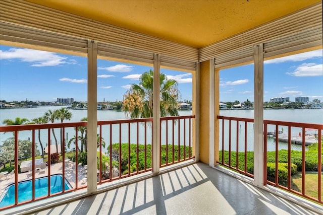 sunroom featuring a water view and a healthy amount of sunlight