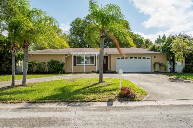 ranch-style home with a front yard and a garage