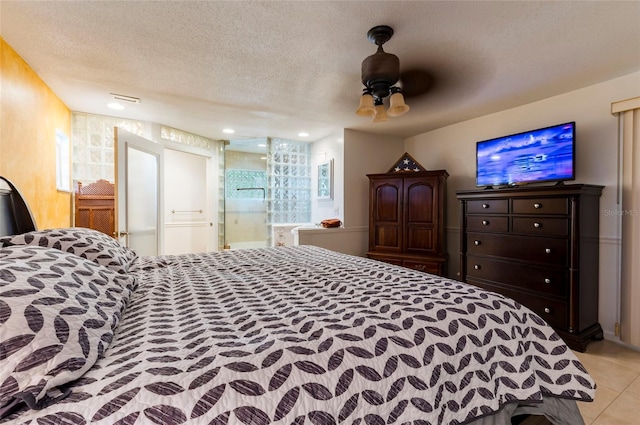 tiled bedroom featuring ceiling fan, a textured ceiling, and multiple windows