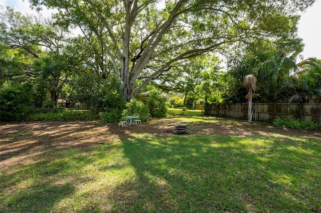 view of yard with an outdoor fire pit