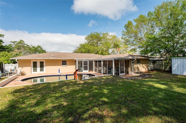 rear view of property with a yard