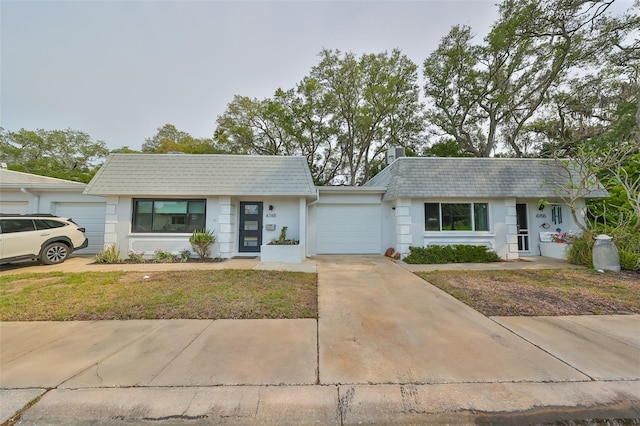 ranch-style home featuring a garage and a front yard