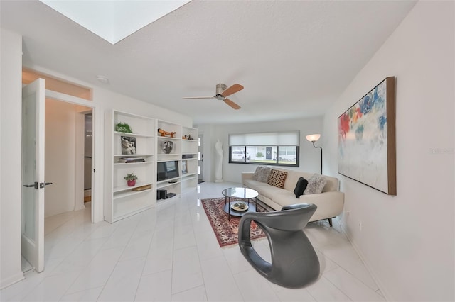 living room featuring a textured ceiling and ceiling fan