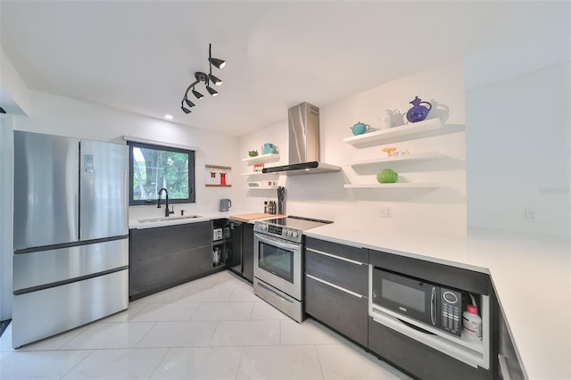 kitchen featuring appliances with stainless steel finishes, track lighting, extractor fan, sink, and light tile patterned floors