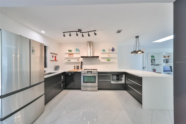 kitchen featuring pendant lighting, wall chimney range hood, sink, kitchen peninsula, and stainless steel appliances