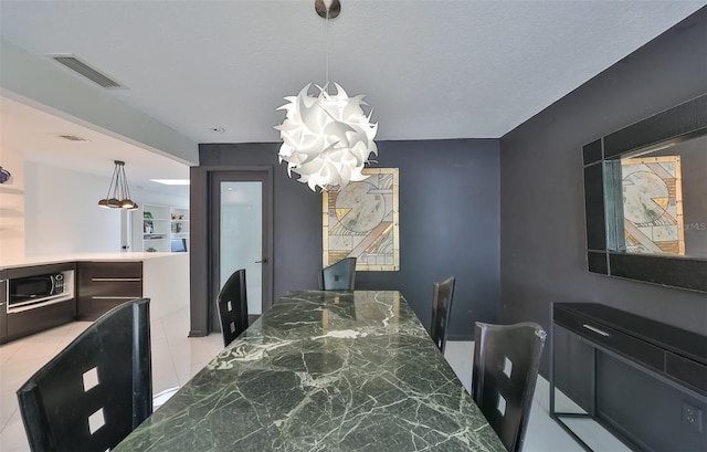 dining area with a textured ceiling and a notable chandelier