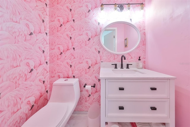 bathroom featuring vanity and toilet