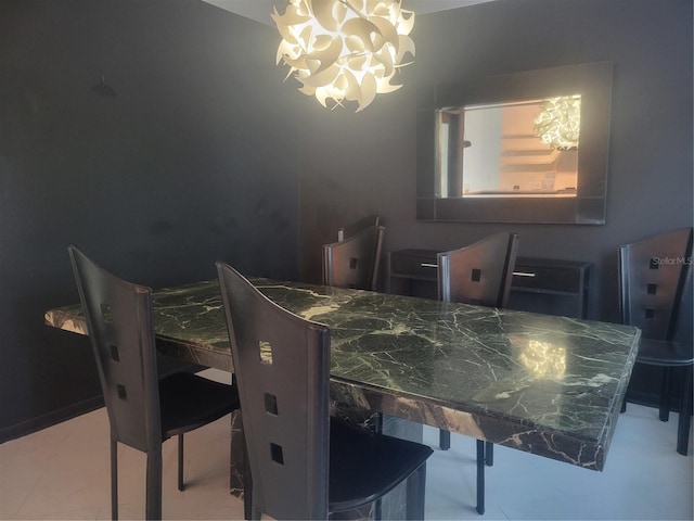 dining space featuring light tile patterned floors and an inviting chandelier