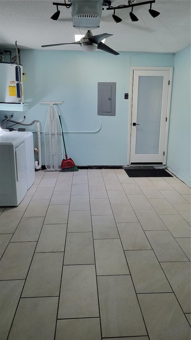 washroom with ceiling fan, water heater, electric panel, light tile patterned floors, and washer and dryer