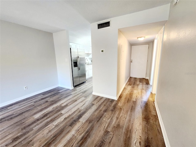 hallway with light hardwood / wood-style floors