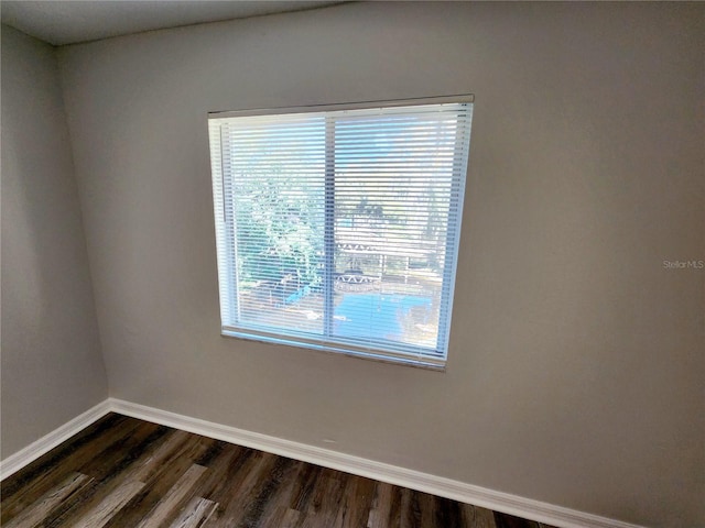 spare room with dark hardwood / wood-style flooring